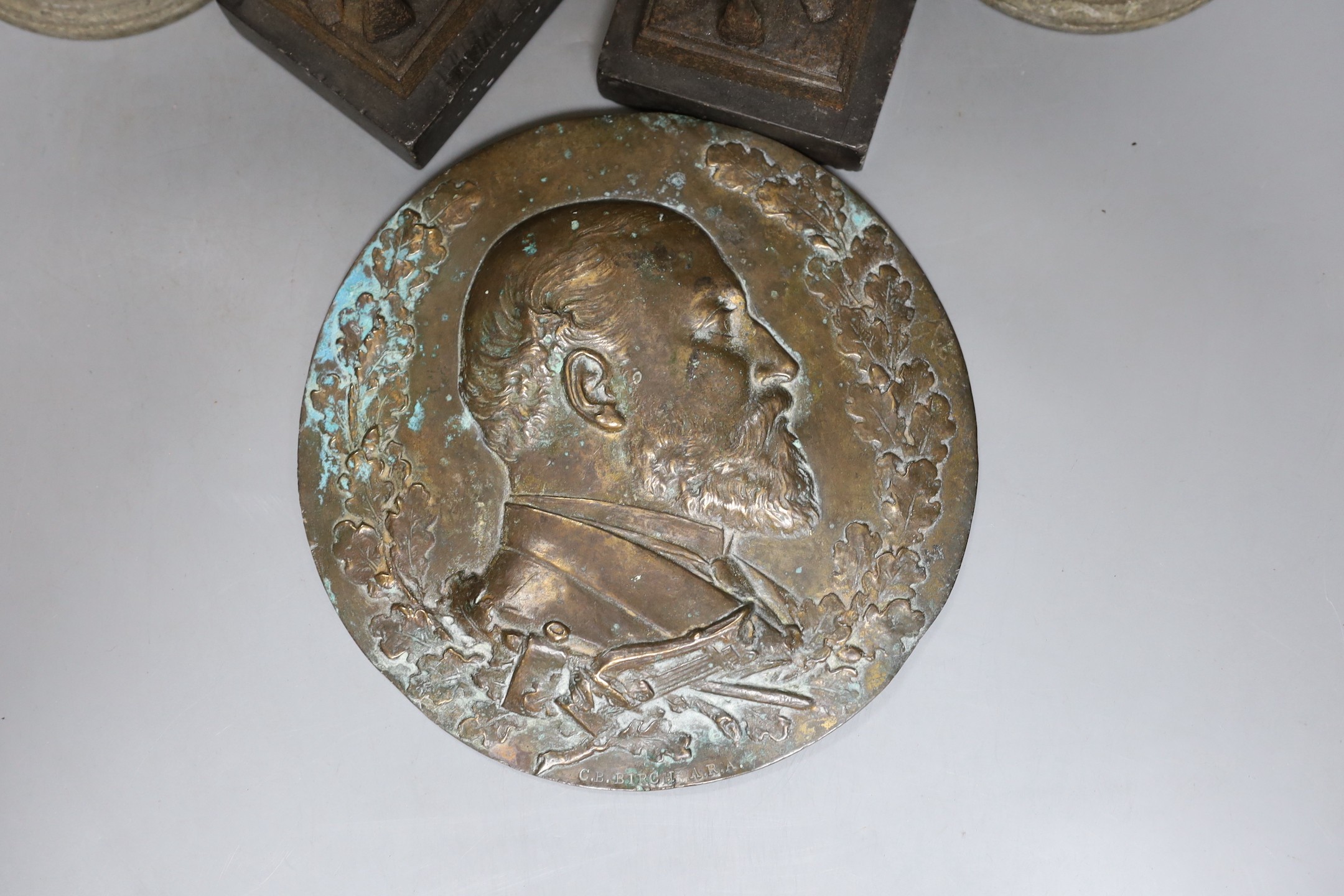 Two pairs of spelter figures, an relief cast portrait plaque, and oil lamp